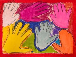 Colourful hand prints painted on a colourful canvas